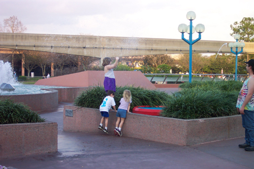 ian, tia and mckenna at epcot playing with the leaping water