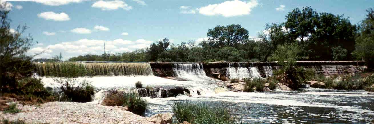 Picture of water flowing over dam on the Concho River at Double M Boer Goats.